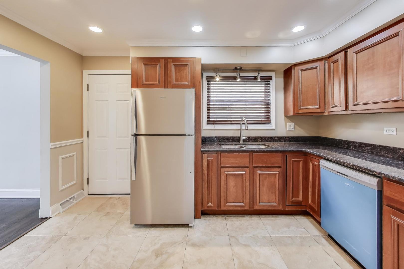 2019 Georgetown Lane, Unit 2019 Waukegan, IL 60085 - Photo 12 of 31 a kitchen with stainless steel appliances granite countertop a refrigerator and a sink