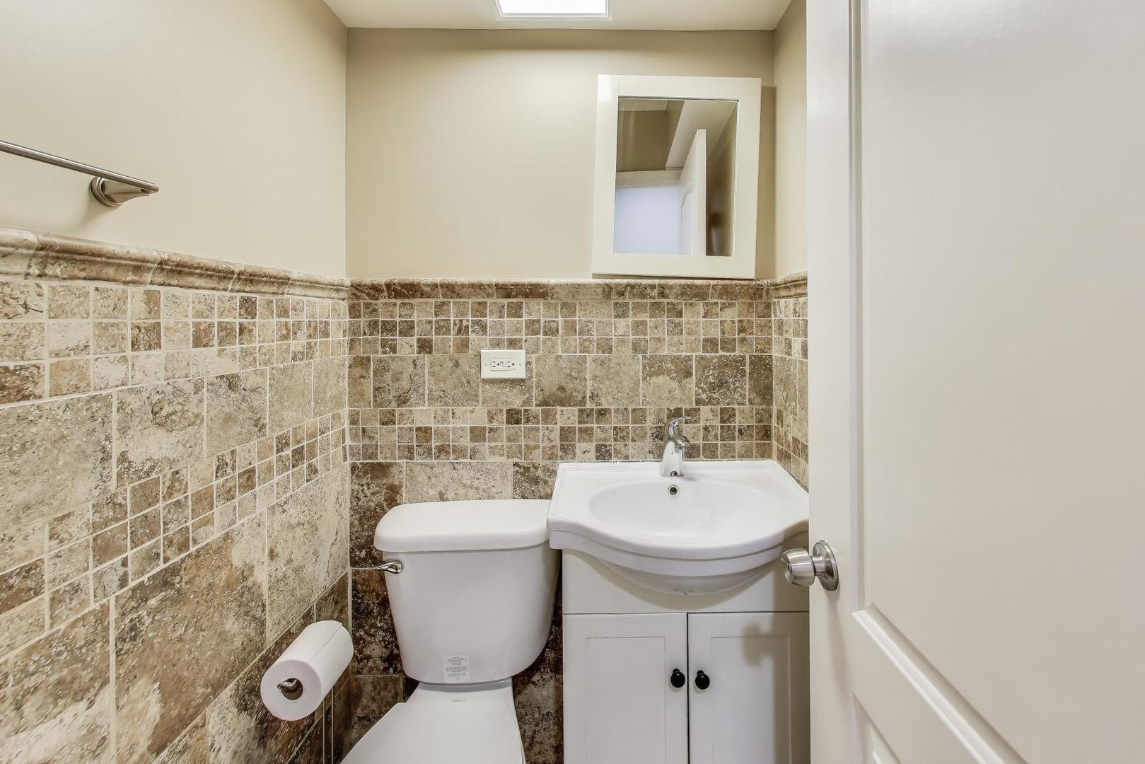 2019 Georgetown Lane, Unit 2019 Waukegan, IL 60085 - Photo 14 of 31 a bathroom with a toilet a sink and mirror