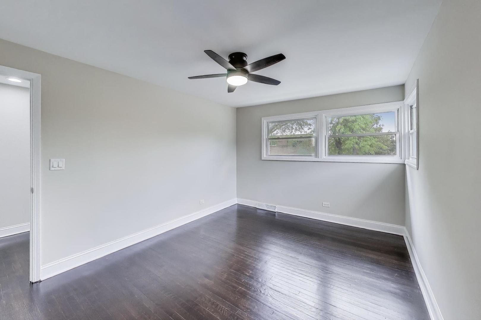 2019 Georgetown Lane, Unit 2019 Waukegan, IL 60085 - Photo 17 of 31 an empty room with wooden floor ceiling fan and windows