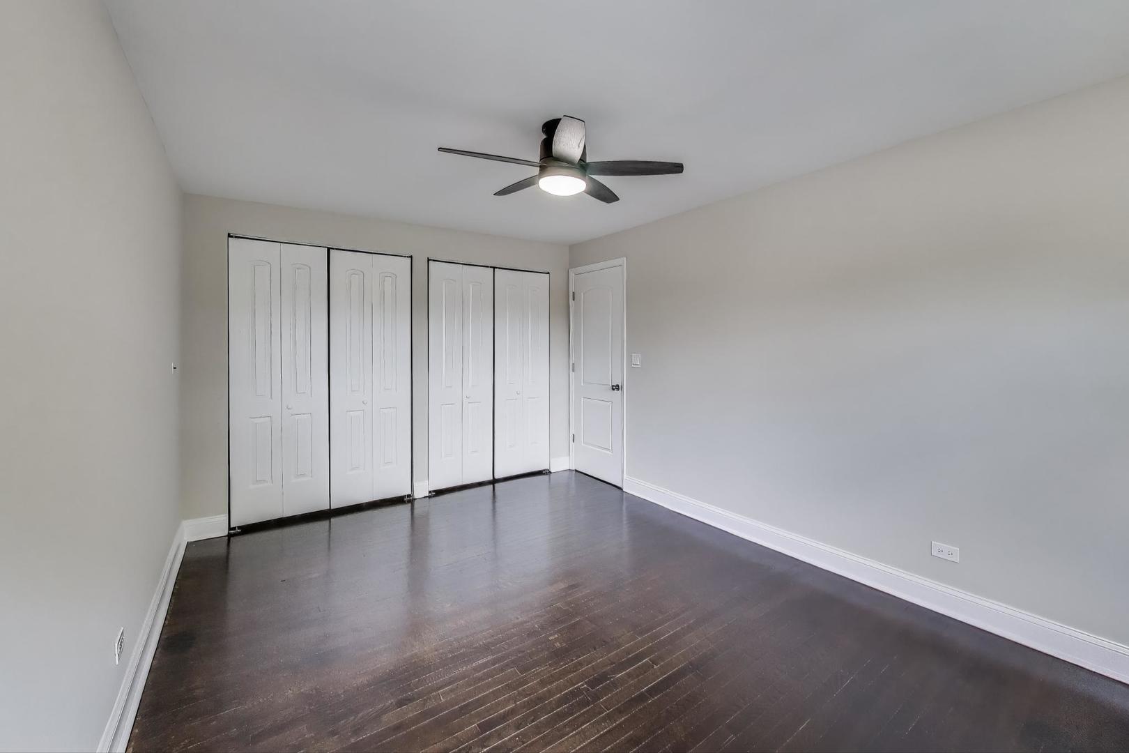 2019 Georgetown Lane, Unit 2019 Waukegan, IL 60085 - Photo 18 of 31 an empty room with wooden floor ceiling fan and window