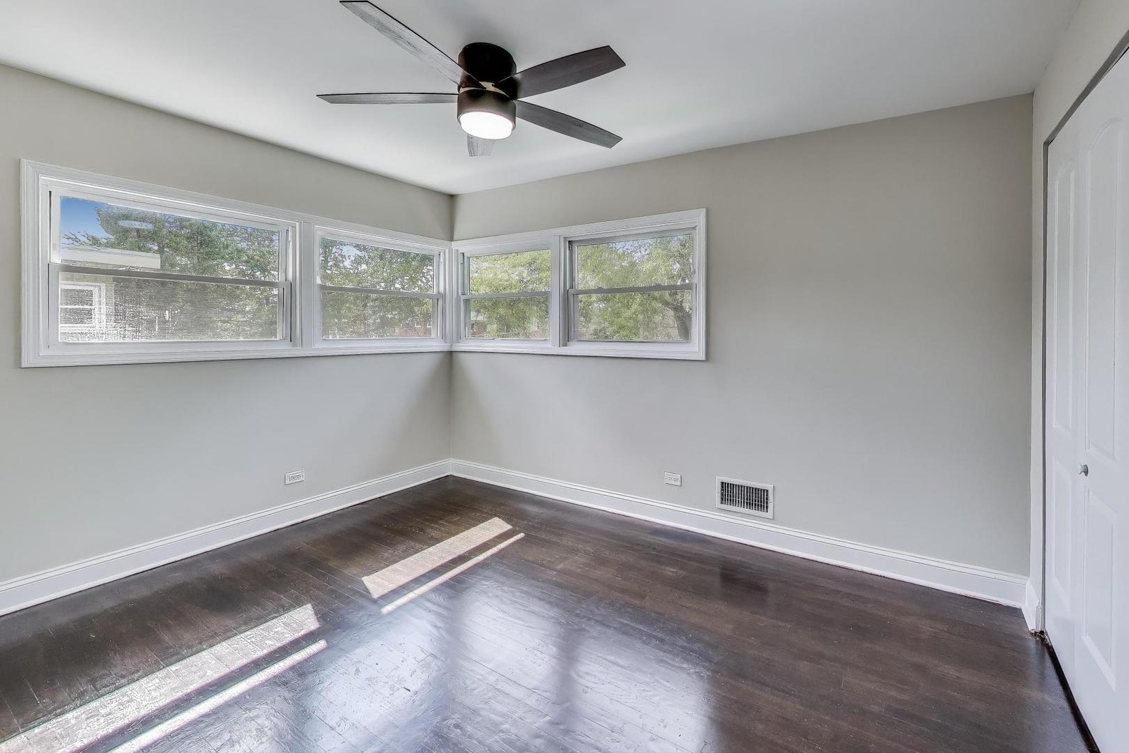 2019 Georgetown Lane, Unit 2019 Waukegan, IL 60085 - Photo 19 of 31 an empty room with wooden floor and windows