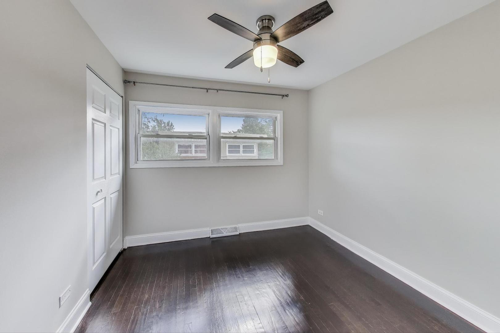 2019 Georgetown Lane, Unit 2019 Waukegan, IL 60085 - Photo 21 of 31 an empty room with wooden floor and windows