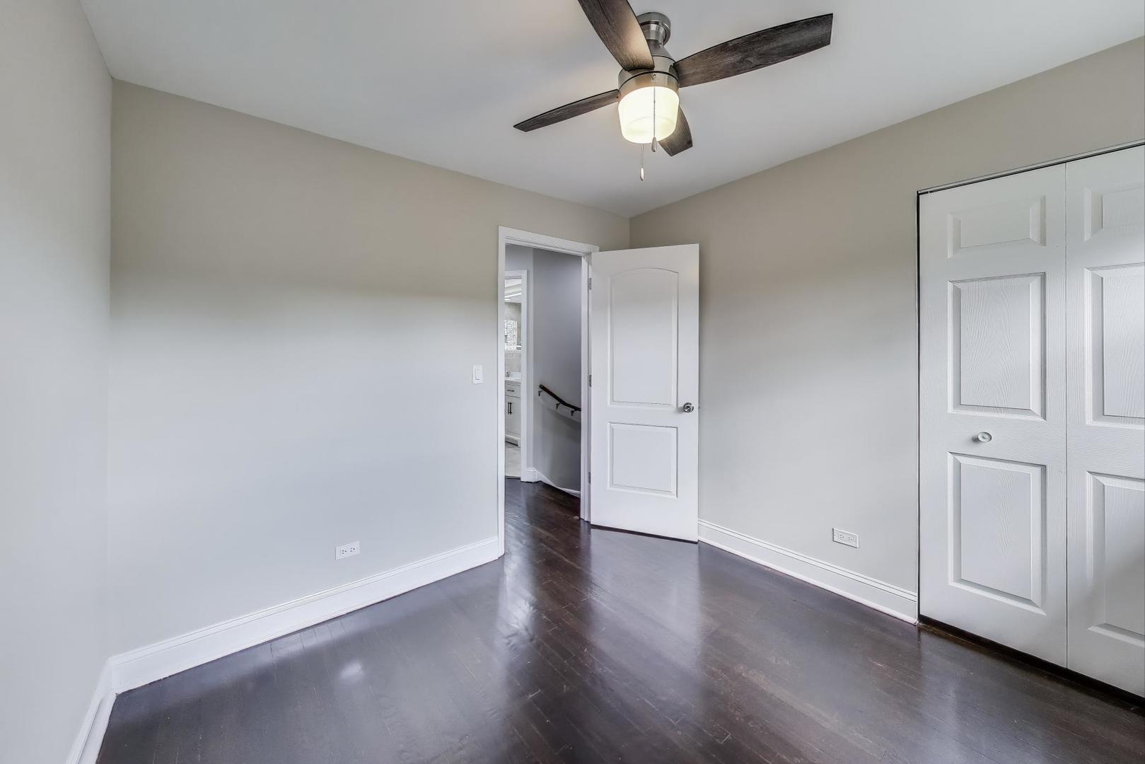 2019 Georgetown Lane, Unit 2019 Waukegan, IL 60085 - Photo 22 of 31 an empty room with wooden floor and ceiling fan