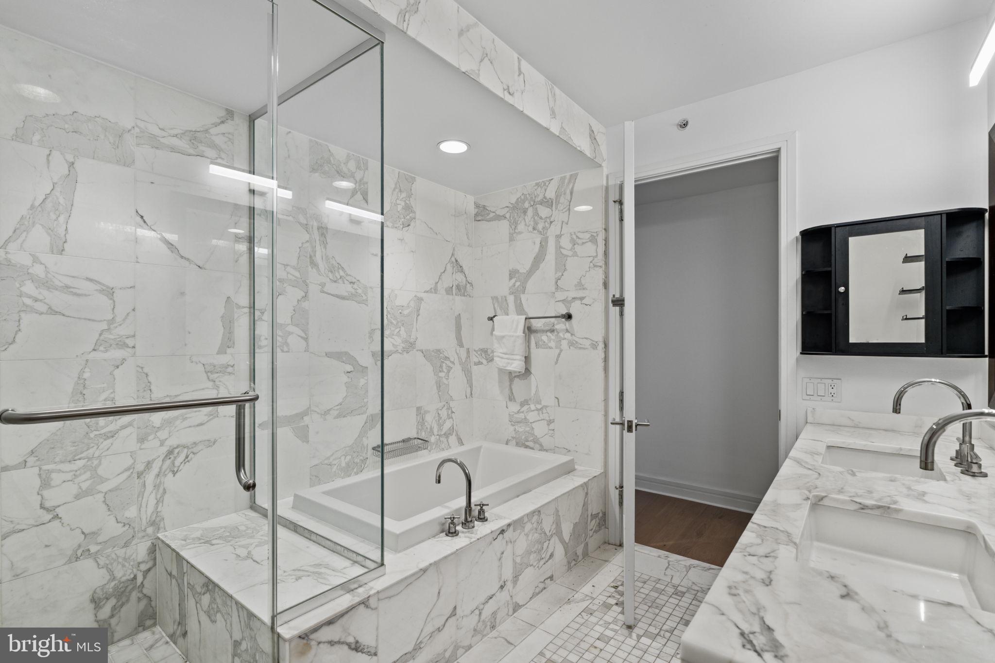 1414 South Penn Square, Unit 5B Philadelphia, PA 19102 - Photo 10 of 38 a bathroom with a tub shower sink and mirror