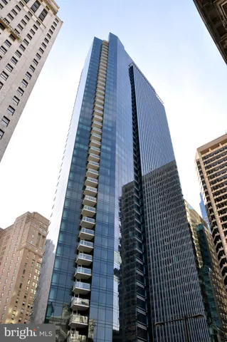 a view of a roof deck with couches chairs and wooden floor