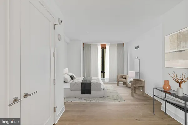 a large bedroom with a bed and large window