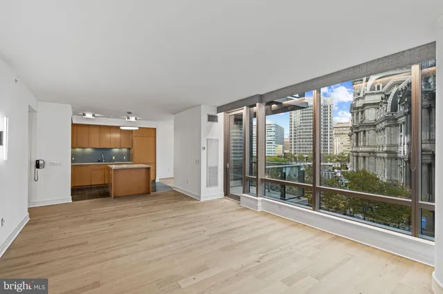 a large kitchen with a sink stainless steel appliances and cabinets