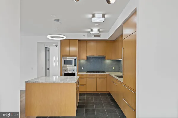 a kitchen with stainless steel appliances granite countertop a sink and cabinets