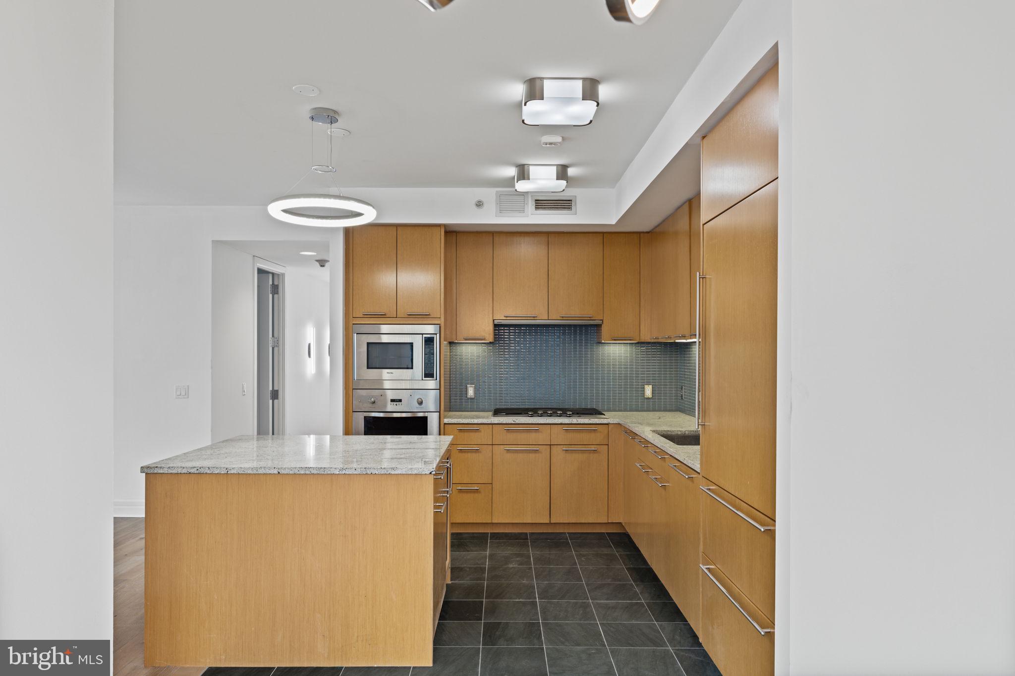 1414 South Penn Square, Unit 5B Philadelphia, PA 19102 - Photo 35 of 38 a large kitchen with a sink stainless steel appliances and cabinets