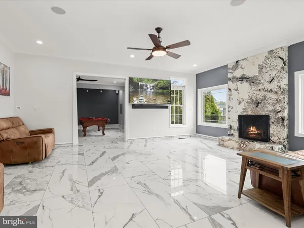 a kitchen with kitchen island granite countertop a sink cabinets and window