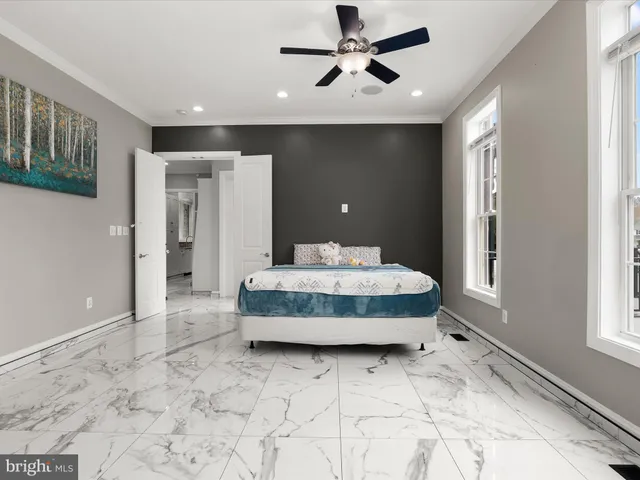 a bedroom with a bed and a window