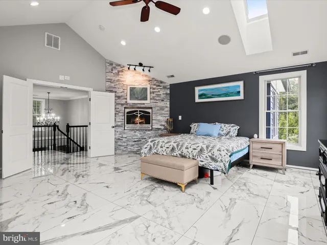 a bedroom with a bed and a mirror on dresser