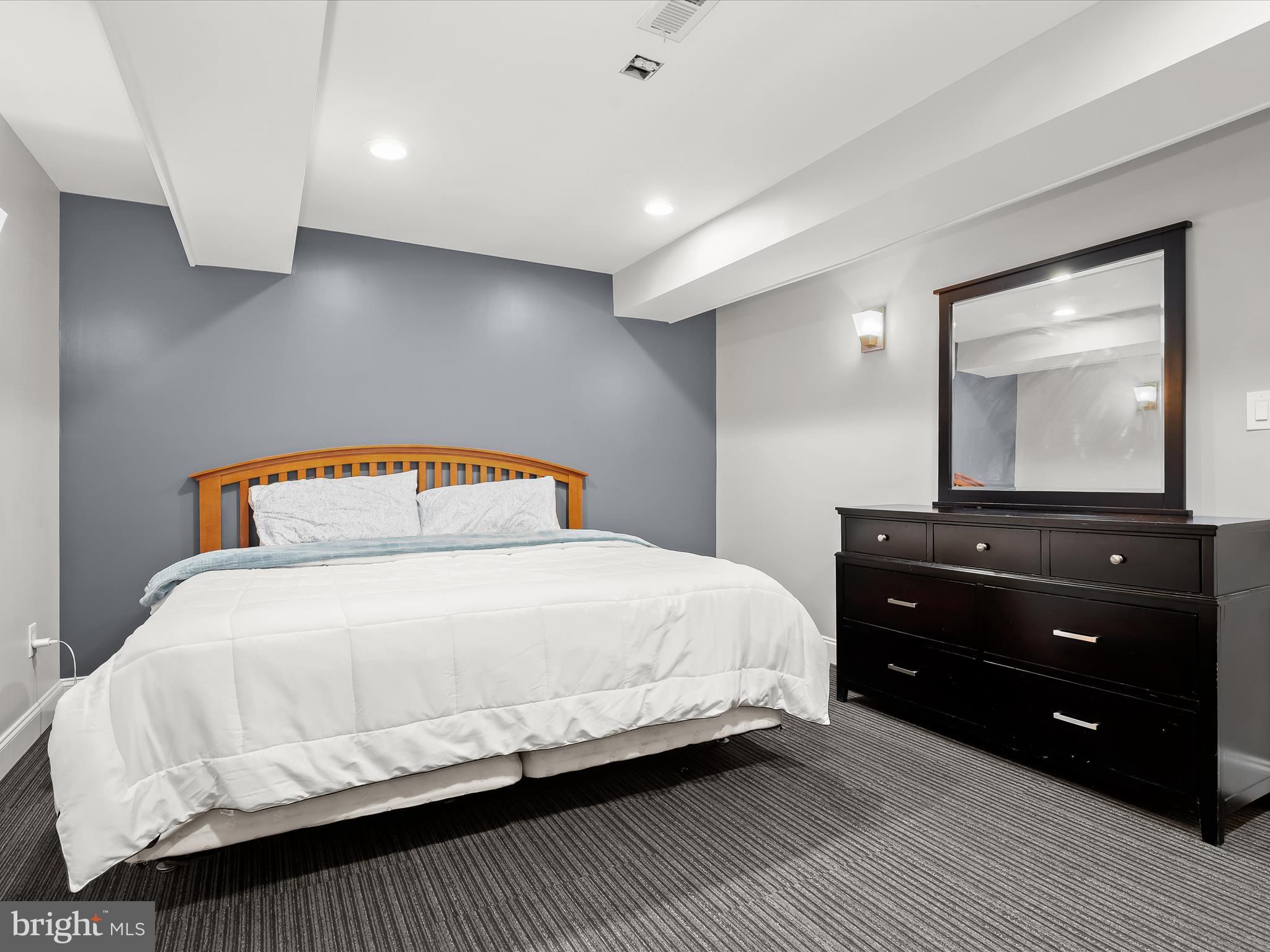 1315 South Seneca Road Middle River, MD 21220 - Photo 64 of 127 a bedroom with a bed and a mirror on dresser