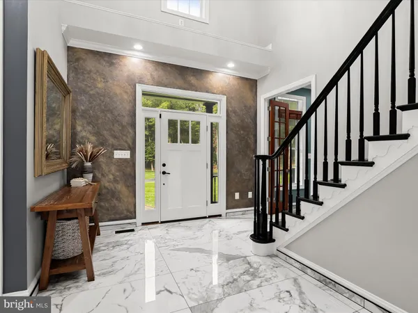 a kitchen with kitchen island granite countertop a stove and a sink