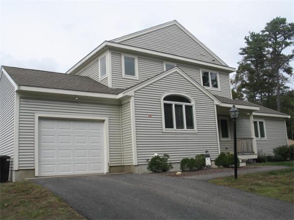 9 Aspen Road, Unit C9 Bourne, MA 02532 - Photo 3 of 30 a front view of a house with a yard and garage
