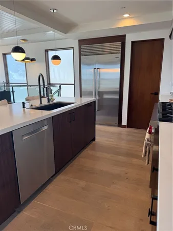 a kitchen with stainless steel appliances a sink and refrigerator