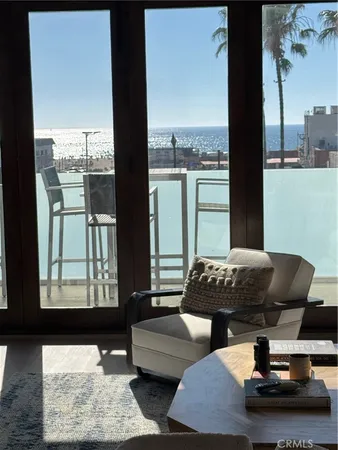 a living room with furniture and a floor to ceiling window