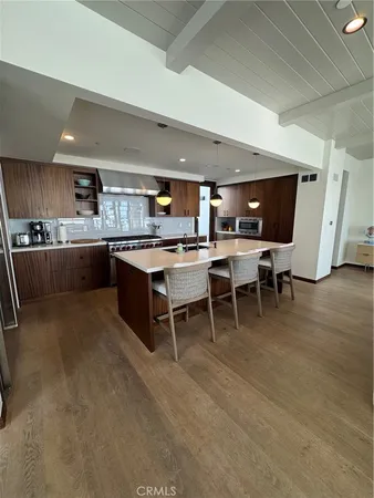 a kitchen with a wooden table and chairs