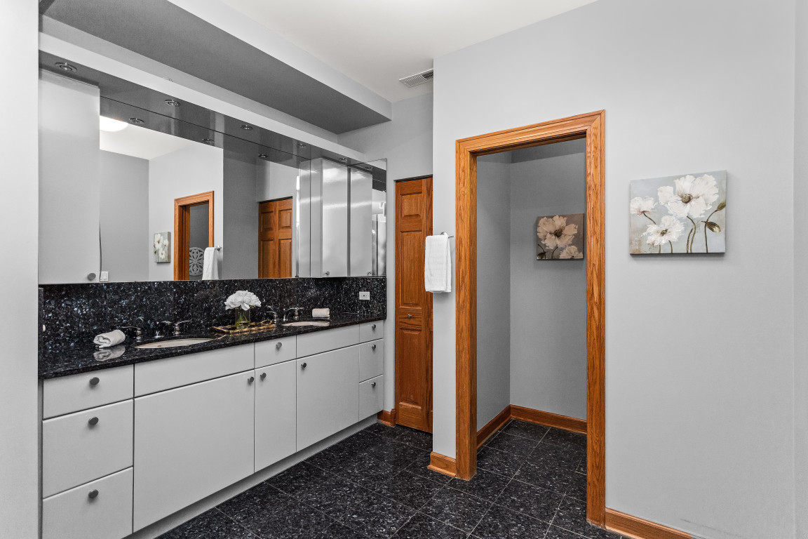 2236 Ridge Avenue Evanston, IL 60201 - Photo 37 of 68 a spacious bathroom with a double vanity sink and a mirror