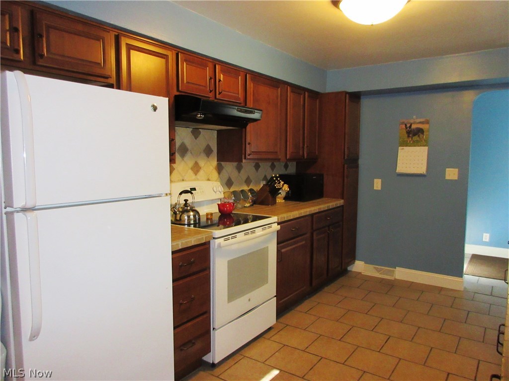 3936 Baird Road Stow, OH 44224 - Photo 5 of 35 New cabinets and counter tops and ceramic flooring complete this kitchen.