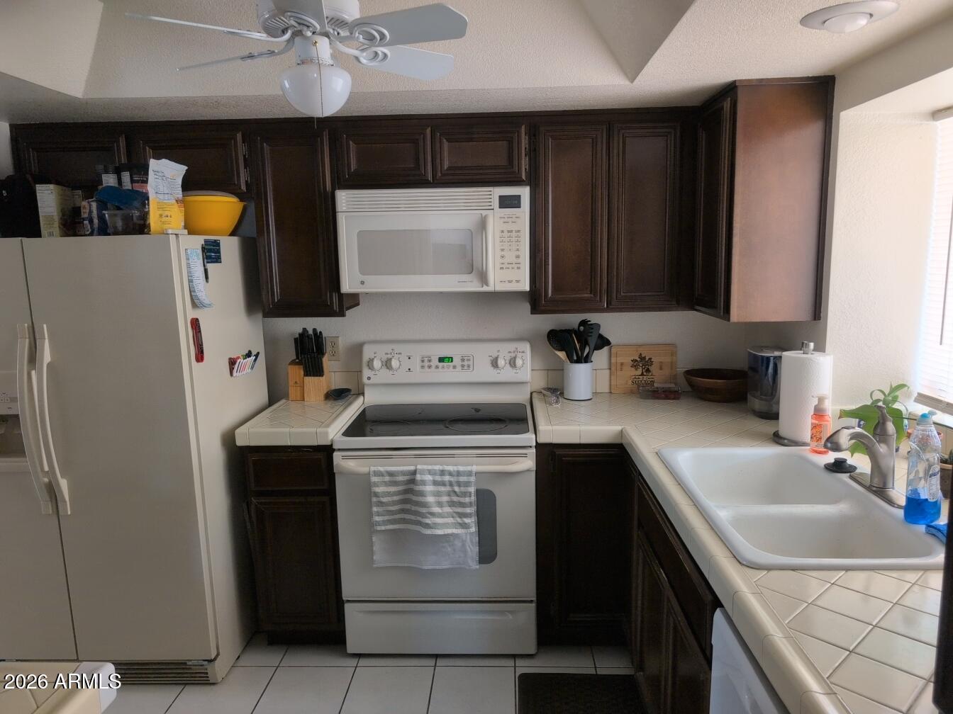 406 West Kings Avenue Phoenix, AZ 85023 - Photo 12 of 45 a kitchen with a sink stove and refrigerator