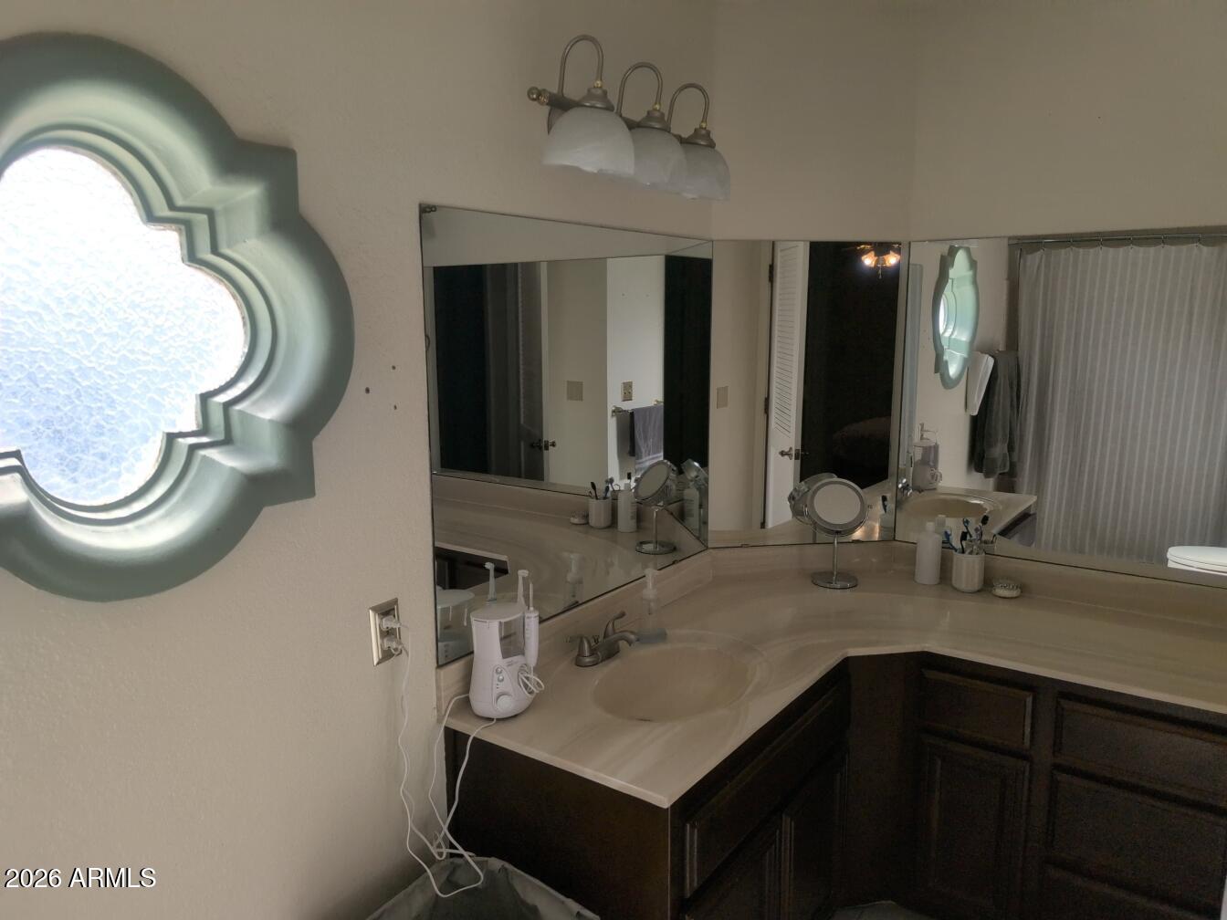 406 West Kings Avenue Phoenix, AZ 85023 - Photo 37 of 45 a bathroom with a sink and a mirror
