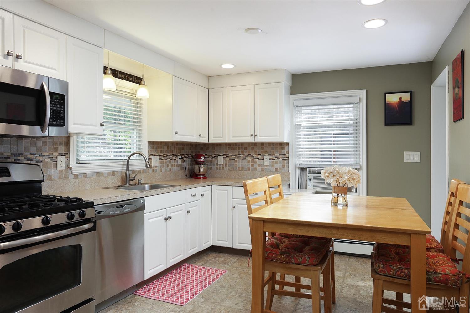 39 West Hill Road Colonia, NJ 07067 - Photo 12 of 26 a kitchen with a sink stove and white cabinets