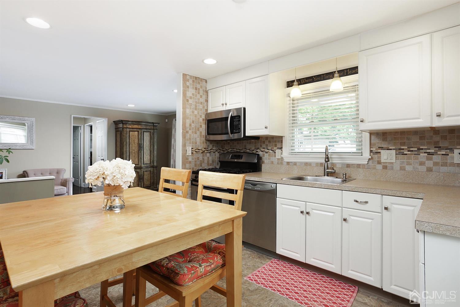 39 West Hill Road Colonia, NJ 07067 - Photo 13 of 26 a kitchen with a sink cabinets and wooden floor