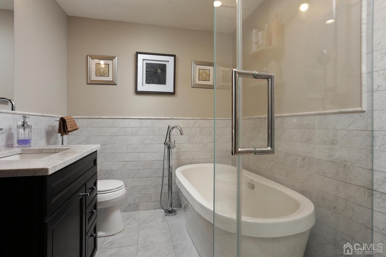 39 West Hill Road Colonia, NJ 07067 - Photo 15 of 26 a bathroom with a sink and bathtub