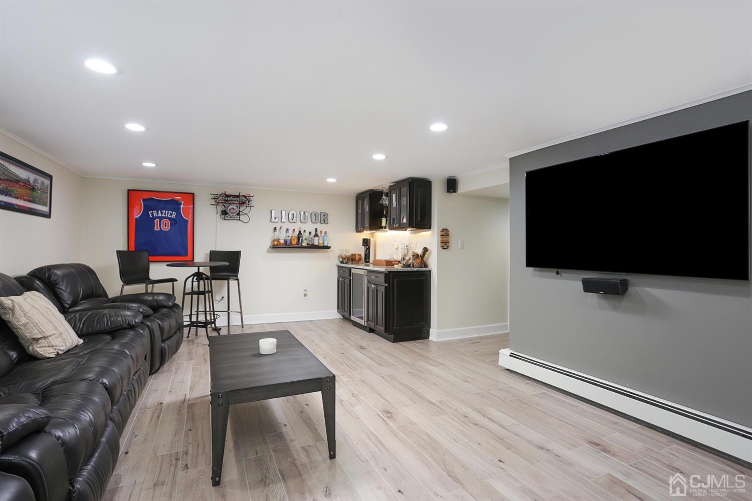 39 West Hill Road Colonia, NJ 07067 - Photo 20 of 26 a living room with furniture and a flat screen tv