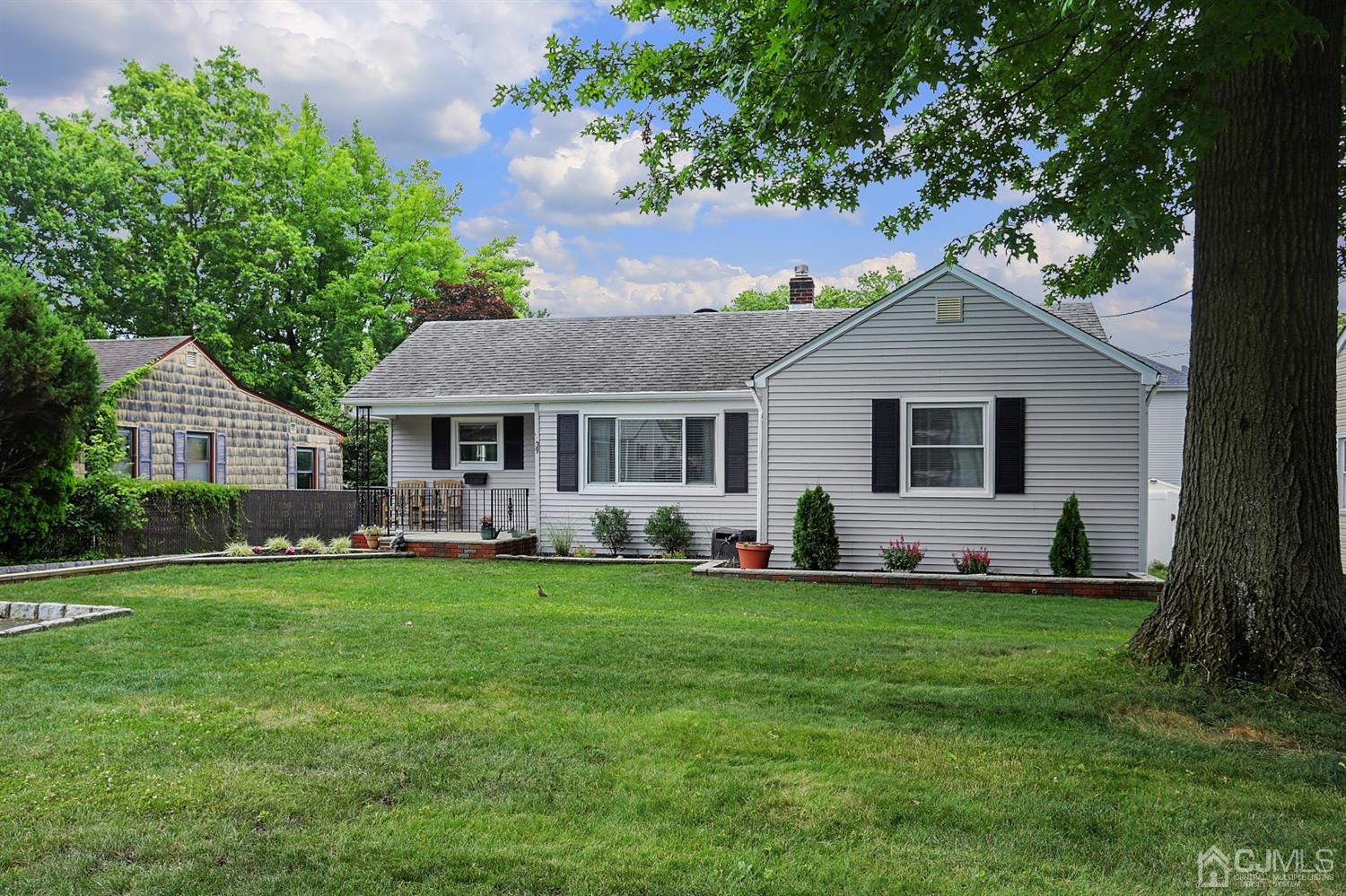 39 West Hill Road Colonia, NJ 07067 - Photo 3 of 26 a front view of a house with a garden and trees