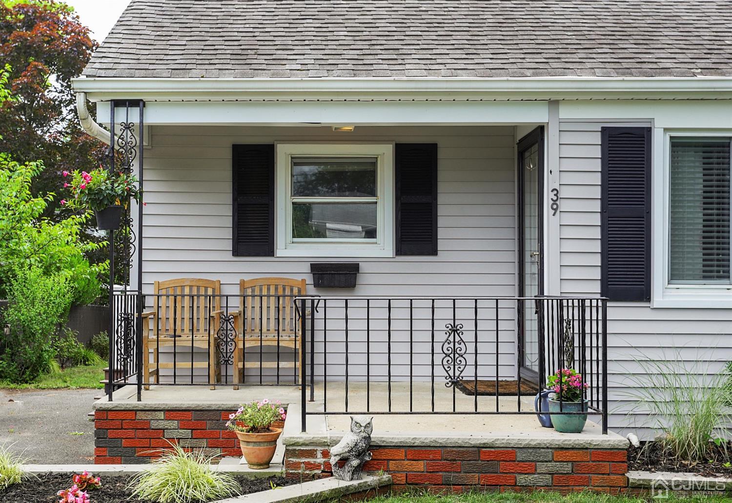 39 West Hill Road Colonia, NJ 07067 - Photo 4 of 26 a front view of a house with a garden