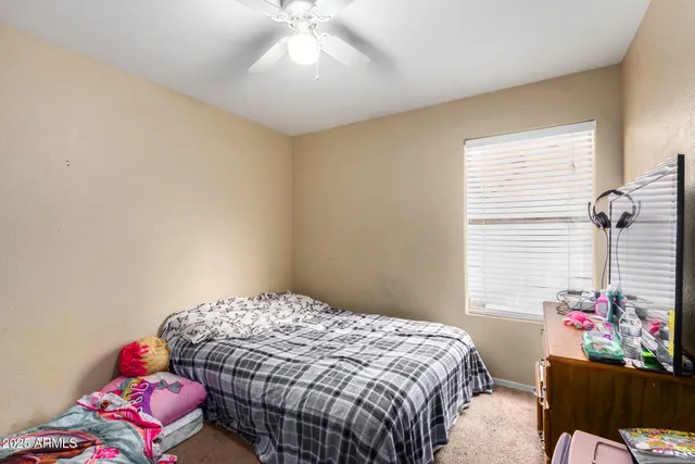 a bedroom with a bed and a window