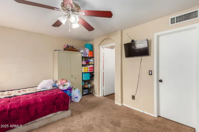 a bedroom with a bed and a walk in closet