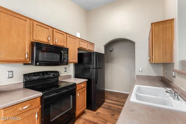 a kitchen with stainless steel appliances wooden cabinets and a stove top oven