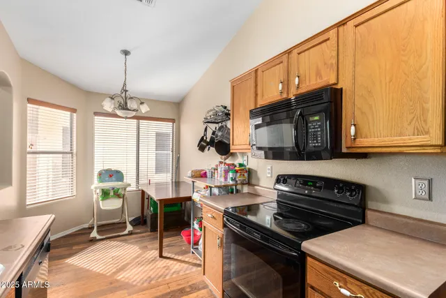 a kitchen with a stove a sink and a microwave