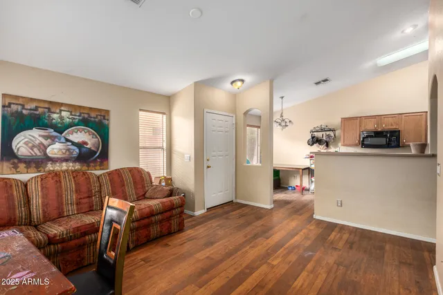 a living room with furniture and a wooden floor