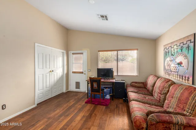 a living room with furniture fireplace and wooden floor