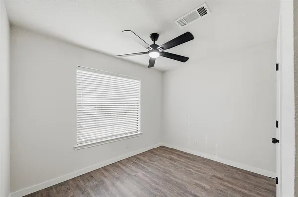 a view of a room with a window and a fan