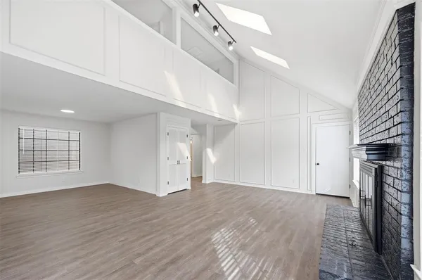 wooden floor in an empty room with a fireplace