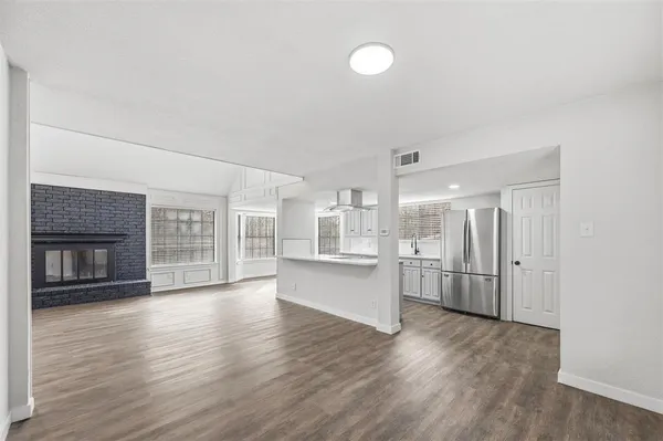 a view of a kitchen with a sink and a refrigerator