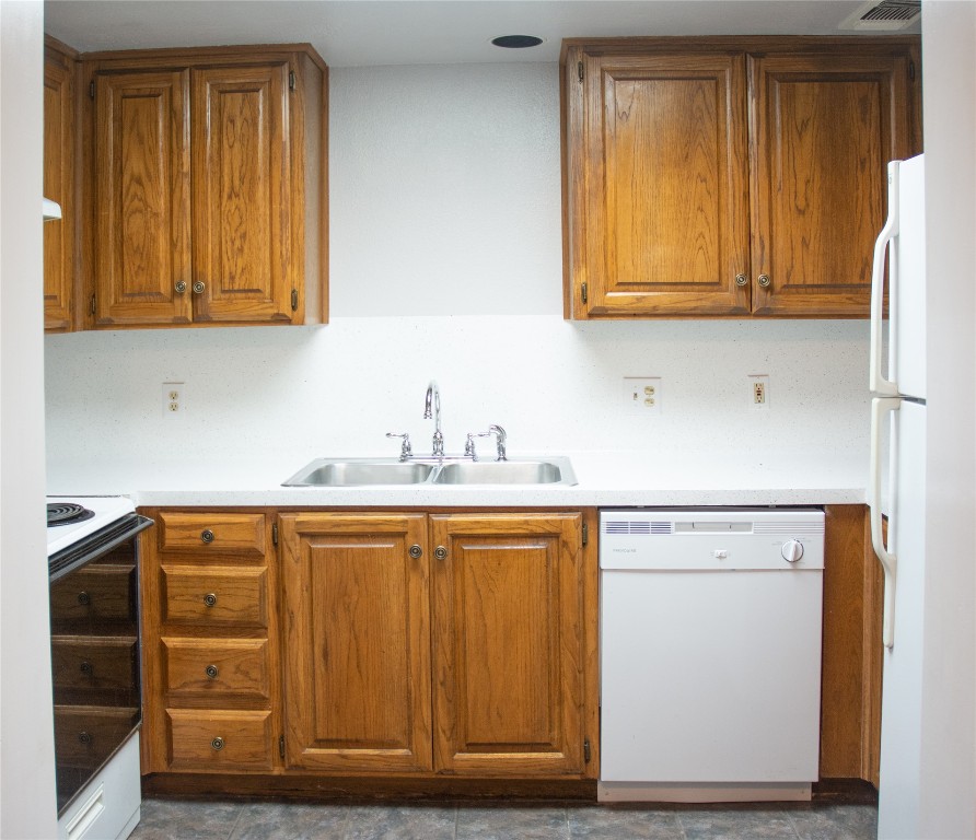 2529 Rio Grande Street, Unit 34 Austin, TX 78705 - Photo 3 of 17 a kitchen with stainless steel appliances granite countertop wooden cabinets and a sink