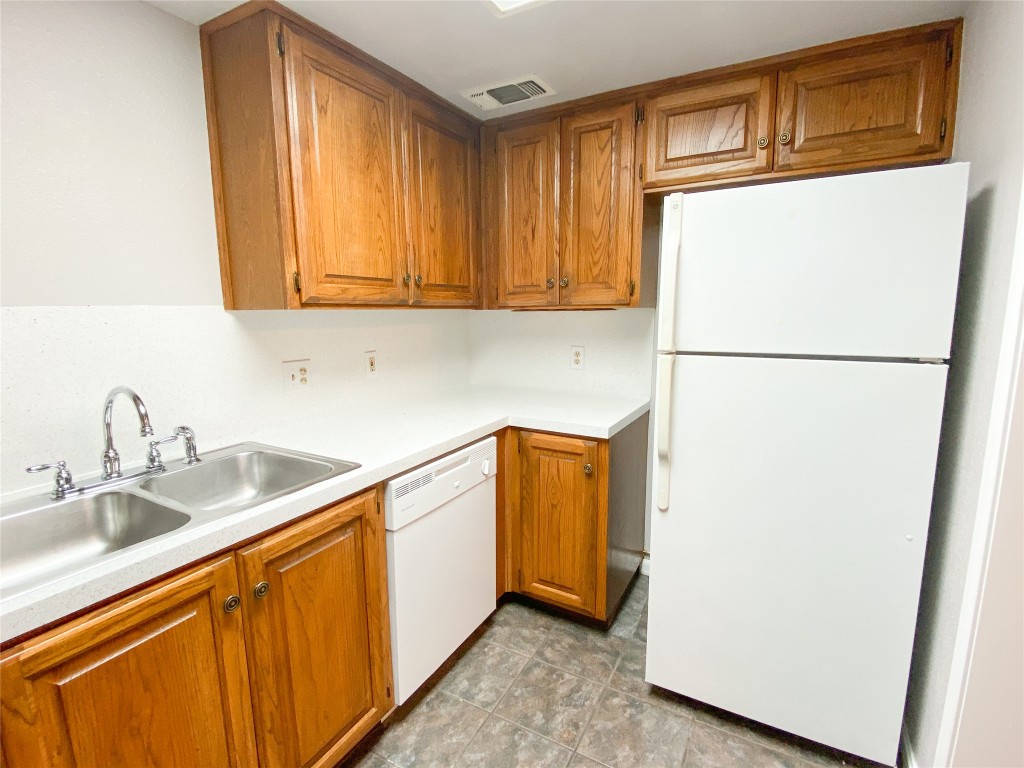 2529 Rio Grande Street, Unit 34 Austin, TX 78705 - Photo 5 of 17 a kitchen with stainless steel appliances granite countertop a refrigerator a sink and cabinets