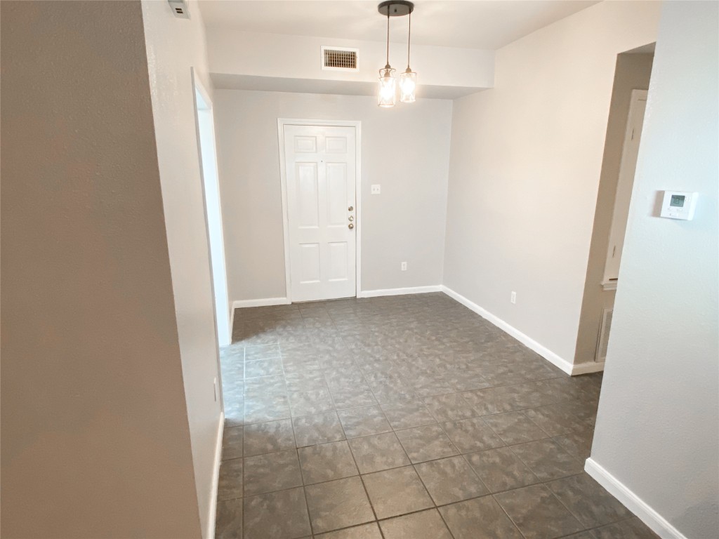 2529 Rio Grande Street, Unit 34 Austin, TX 78705 - Photo 6 of 17 an empty room with chandelier fan