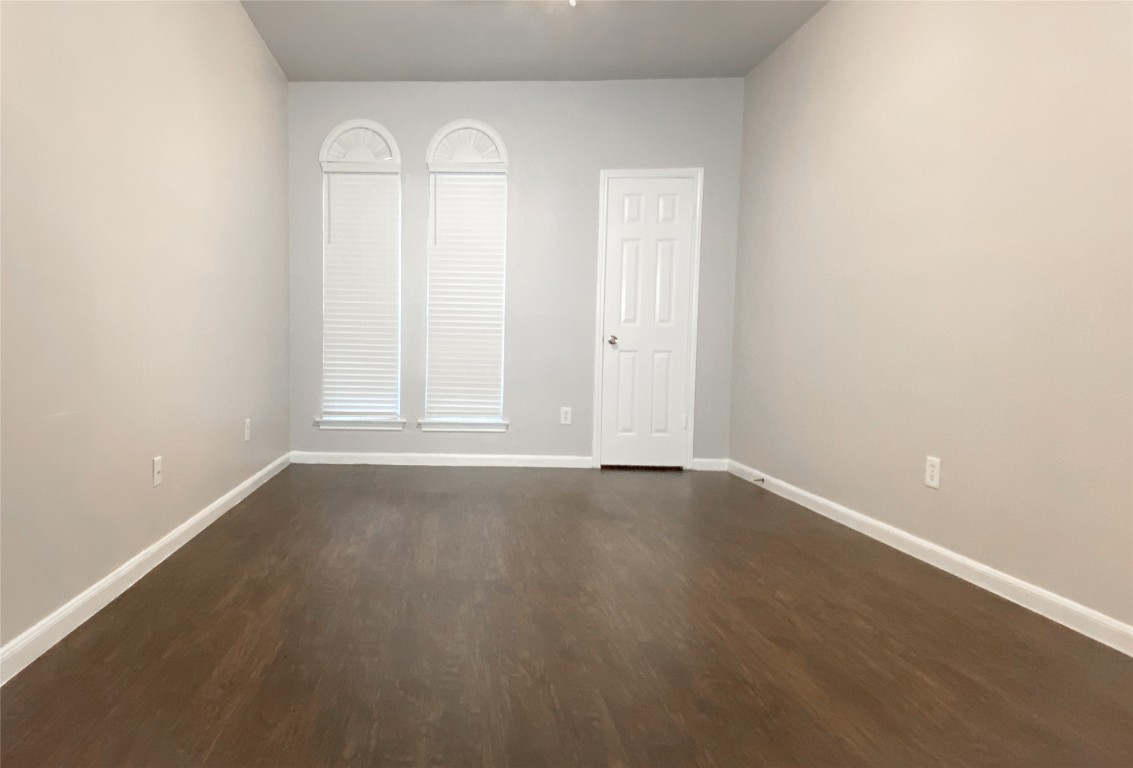 2529 Rio Grande Street, Unit 34 Austin, TX 78705 - Photo 8 of 17 an empty room with wooden floor and window