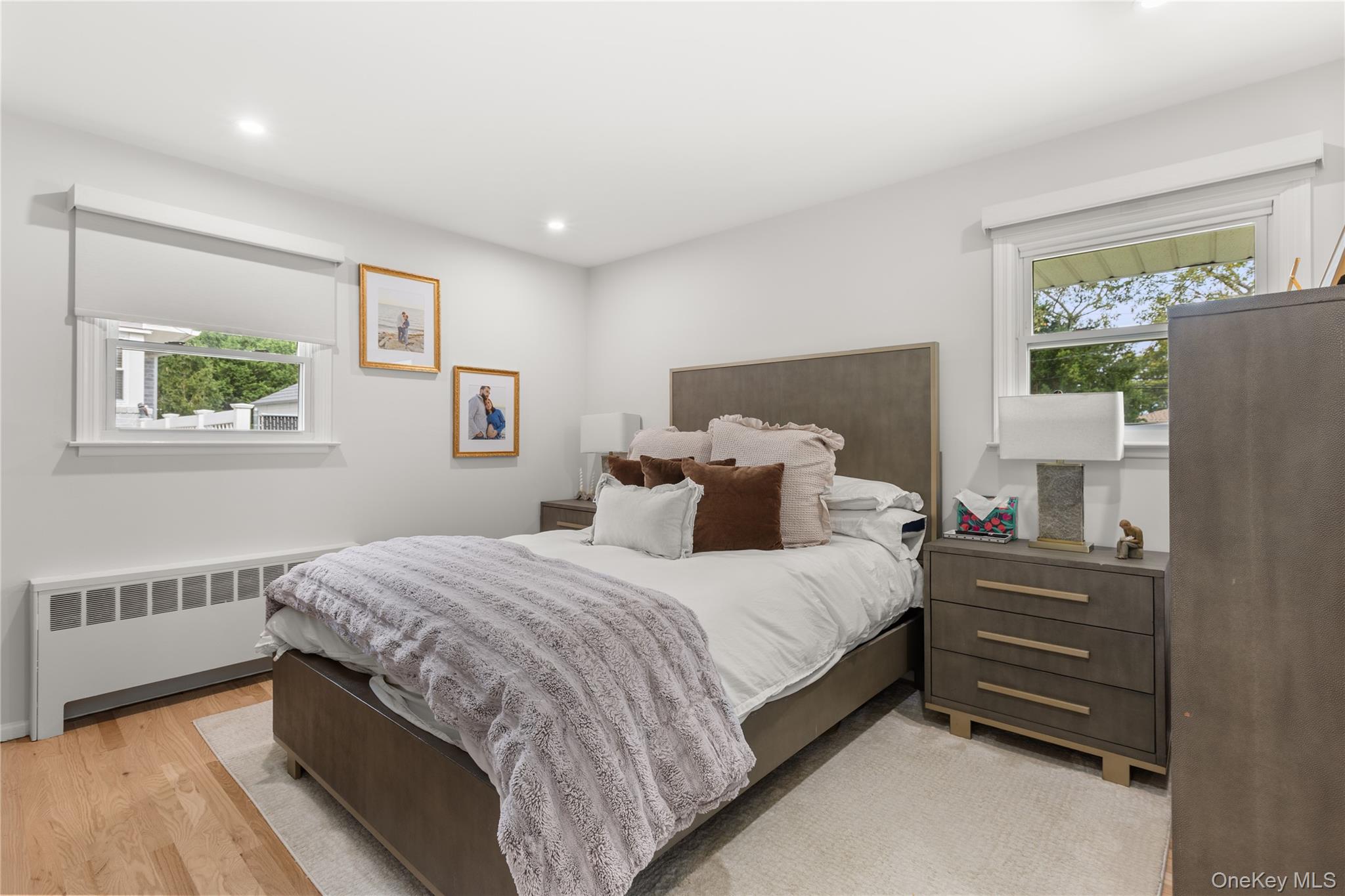 205 Timber Point Road East Islip, NY 11730 - Photo 7 of 16 Bedroom featuring radiator, light wood-style flooring, and recessed lighting
