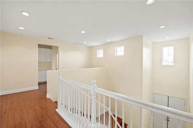 a view of a hallway with wooden floor
