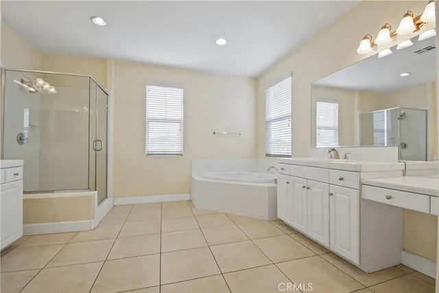 a spacious bathroom with a shower a mirror and a bathtub
