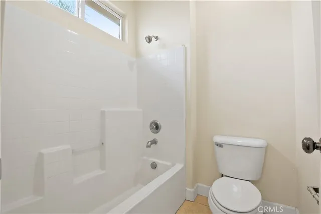a bathroom with a toilet and a bathtub
