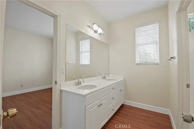 a bathroom with a double vanity sink and a mirror